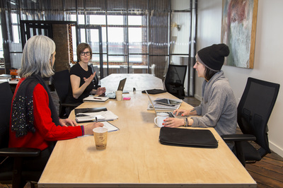 Architects and designers collaborating in a bright open workspace.