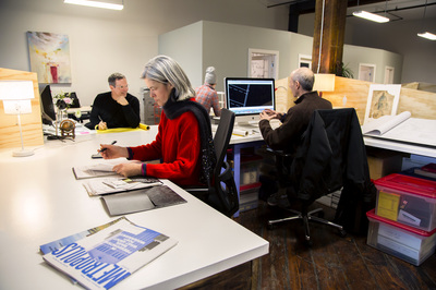 Modern coworking space with large desks and natural light at SHARED Brooklyn.